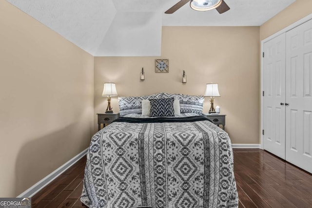 bedroom with wood tiled floor, baseboards, and a closet