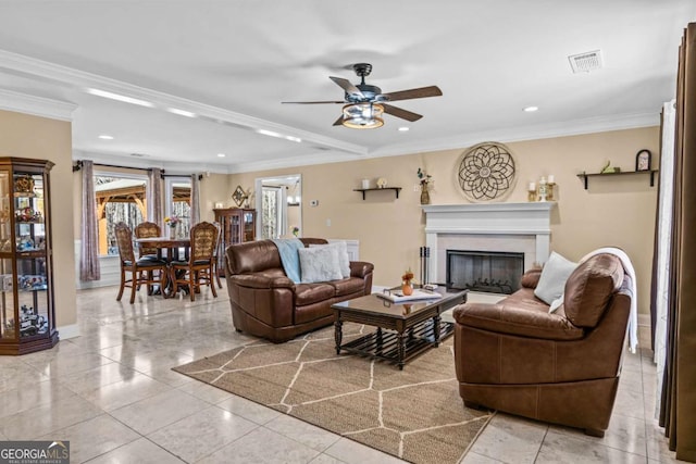 living area featuring crown molding, recessed lighting, a fireplace, and baseboards