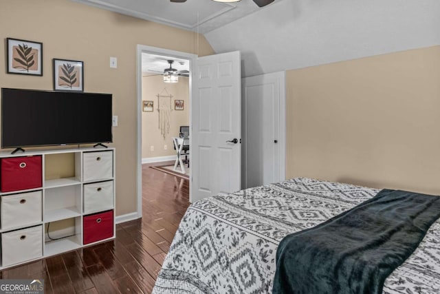 bedroom featuring a ceiling fan, dark wood-style flooring, vaulted ceiling, and baseboards