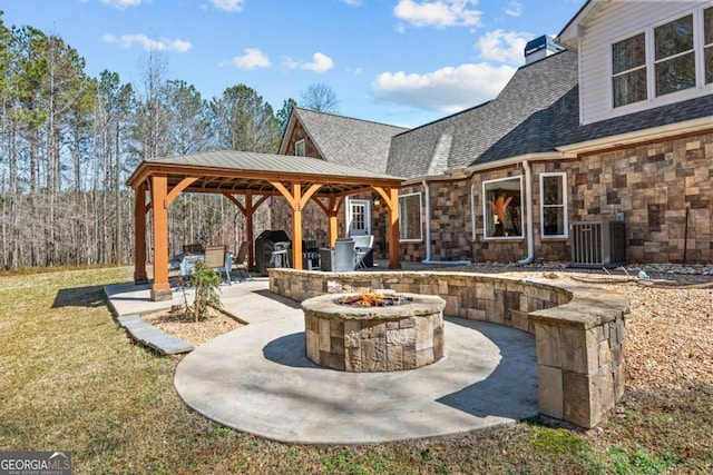 view of patio featuring a gazebo, an outdoor fire pit, and central AC