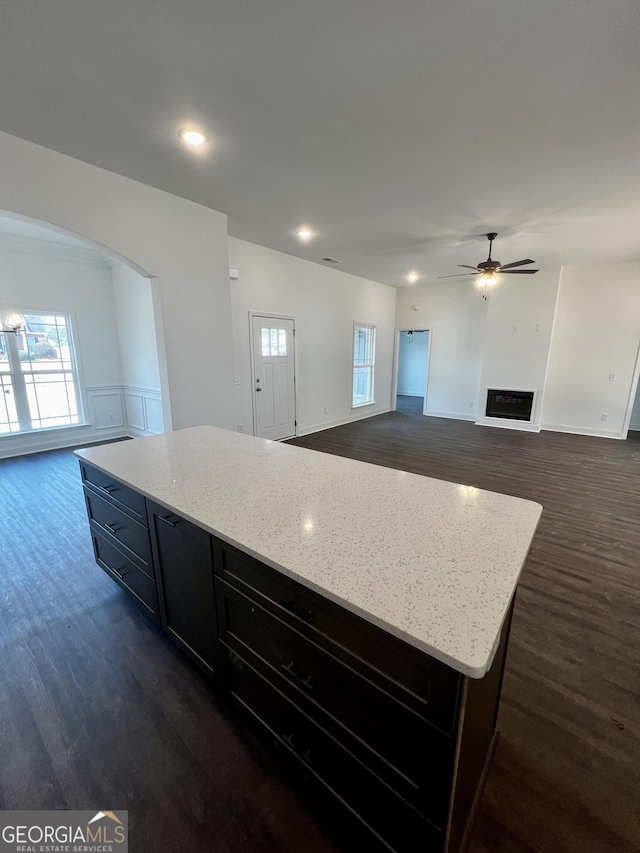 kitchen with a center island, open floor plan, and dark wood-style flooring