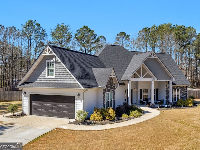 view of front facade featuring a garage, fence, driveway, roof with shingles, and a front lawn