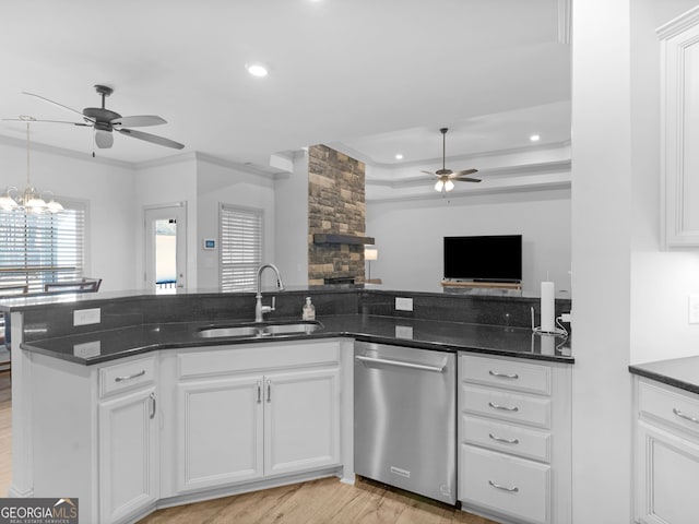 kitchen with open floor plan, white cabinets, a sink, dishwasher, and ceiling fan with notable chandelier