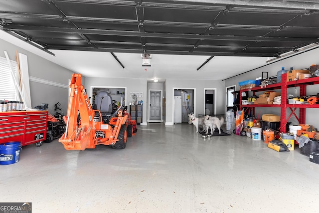 garage featuring fridge and a garage door opener