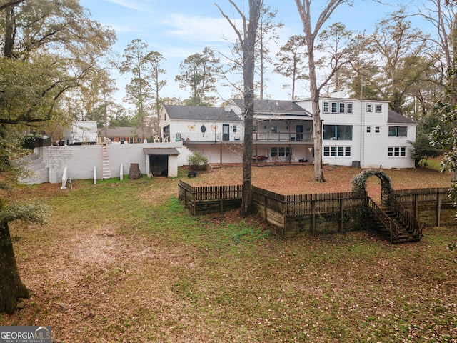 rear view of property featuring a yard