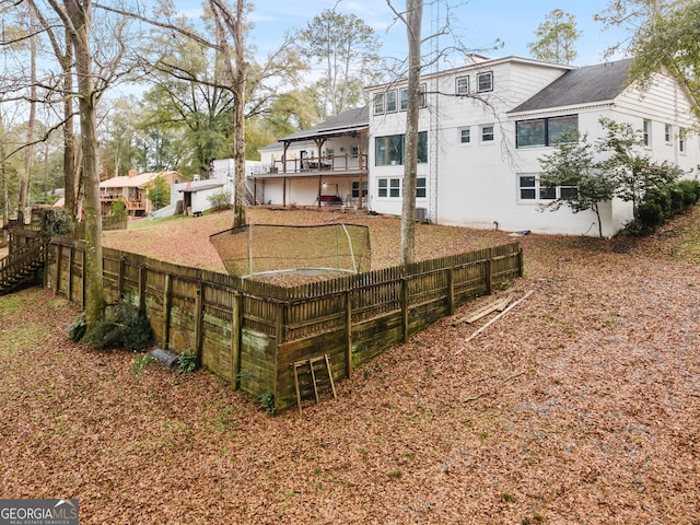 view of yard featuring a balcony and a fenced backyard