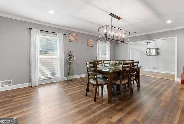 dining area featuring ornamental molding, visible vents, and dark wood-type flooring