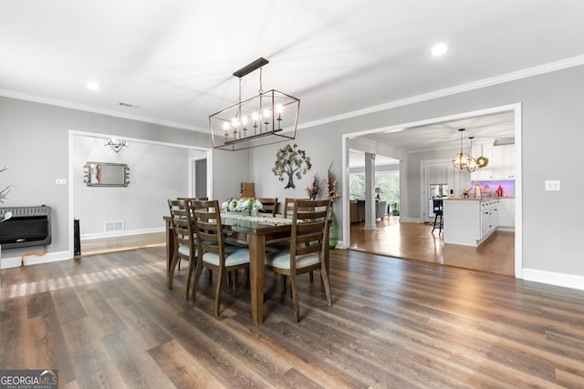 dining area featuring ornamental molding, dark wood finished floors, and heating unit