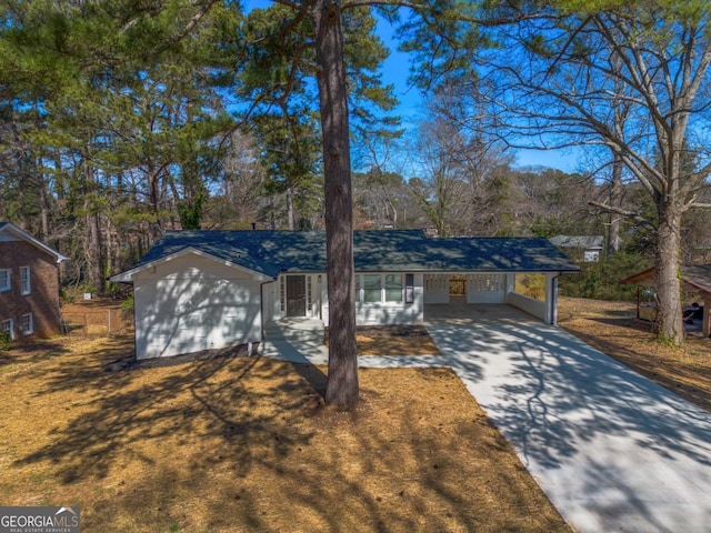 single story home featuring an attached carport and driveway