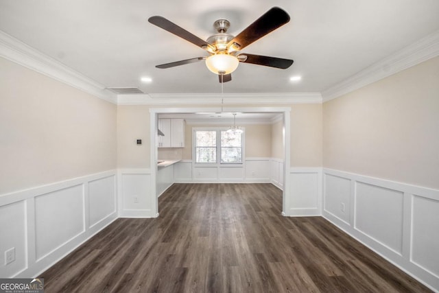 unfurnished room featuring visible vents, dark wood finished floors, crown molding, and ceiling fan with notable chandelier