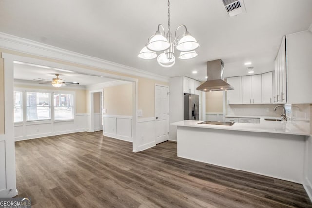 kitchen featuring island range hood, a sink, white cabinetry, light countertops, and stainless steel fridge with ice dispenser