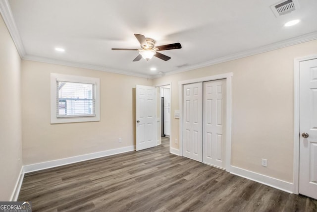 unfurnished bedroom featuring dark wood-style floors, recessed lighting, visible vents, ornamental molding, and baseboards