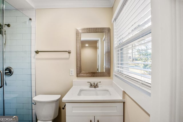 full bath featuring toilet, ornamental molding, a tile shower, and vanity