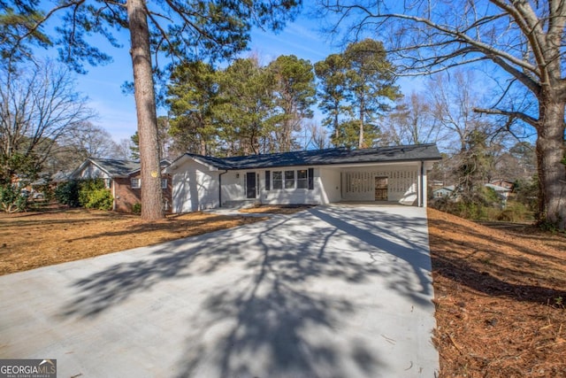 view of front of home featuring driveway and an attached carport