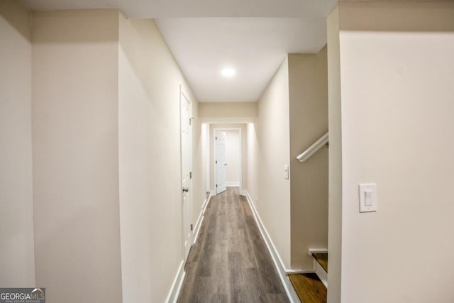 hall with baseboards and dark wood finished floors