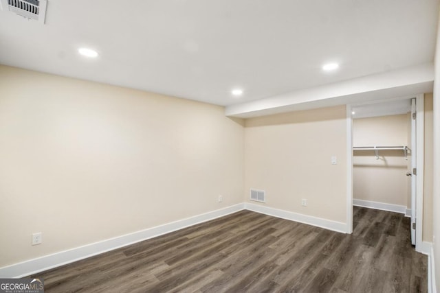 finished basement with dark wood-type flooring, recessed lighting, visible vents, and baseboards