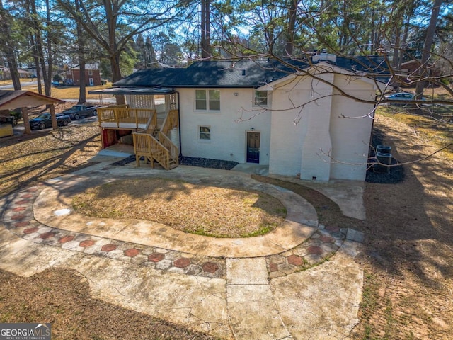 exterior space featuring brick siding and stairway