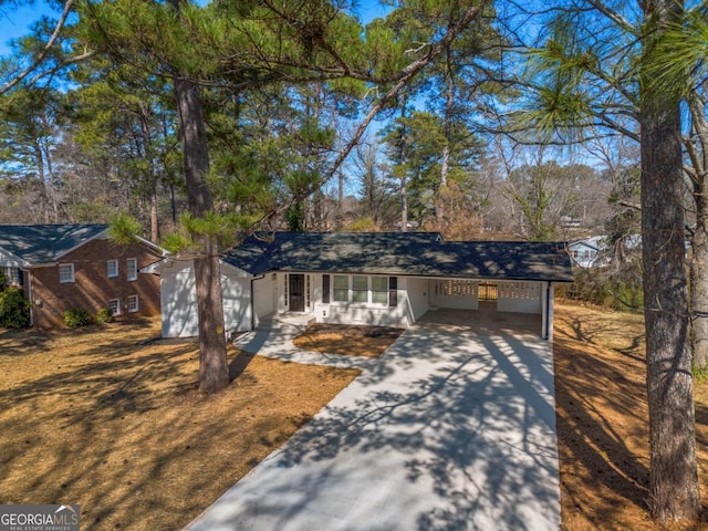 ranch-style house with driveway and a carport