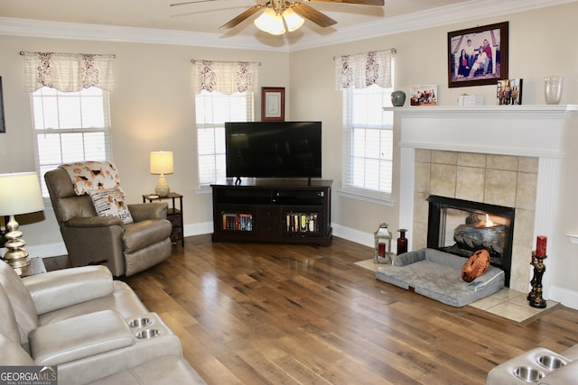 living area with ornamental molding, a healthy amount of sunlight, and wood finished floors