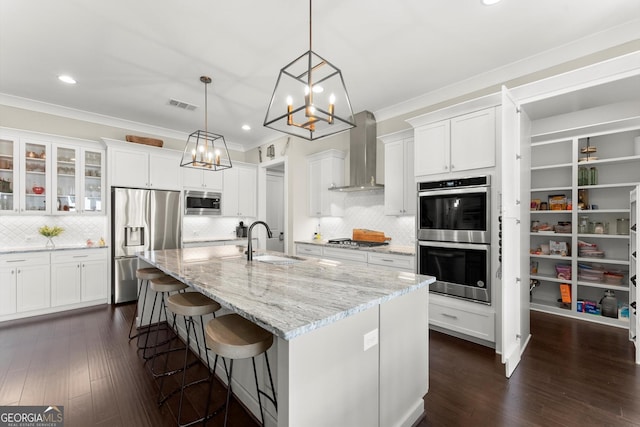 2903 Eva Clb, Acworth, GA 30101 - kitchen with stainless steel appliances, wall chimney range hood, a chandelier, crown molding, and white cabinetry