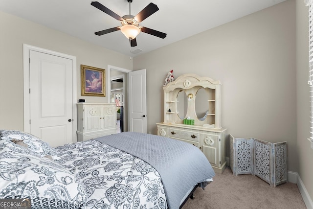 bedroom with visible vents, baseboards, a ceiling fan, and light colored carpet