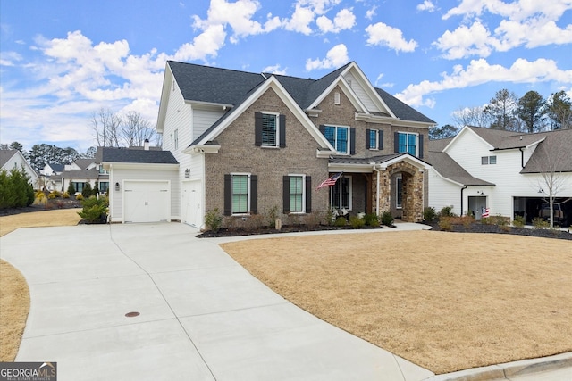 view of front of property with an attached garage, brick siding, driveway, and a front lawn