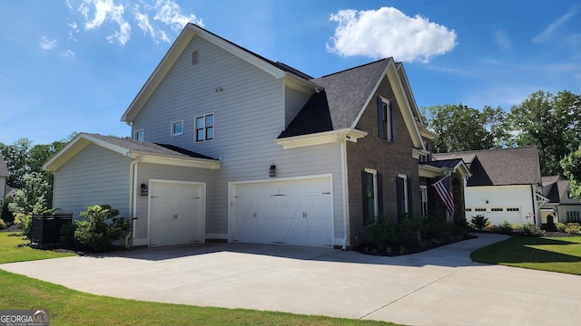 2903 Eva Clb, Acworth, GA 30101 - view of home's exterior with concrete driveway, a garage, brick siding, and roof with shingles