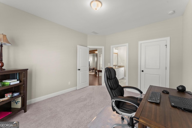 carpeted office with baseboards
