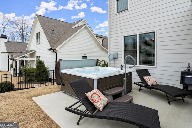 view of patio with fence and a hot tub