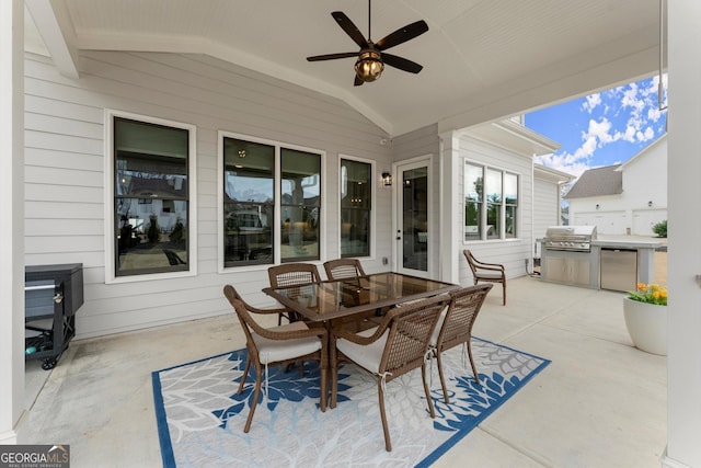 view of patio / terrace featuring a grill, an outdoor kitchen, a ceiling fan, and outdoor dining space