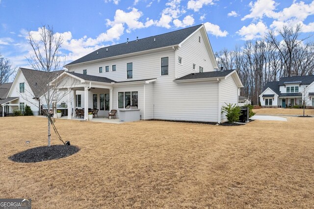 back of property with a patio area, ceiling fan, and a yard