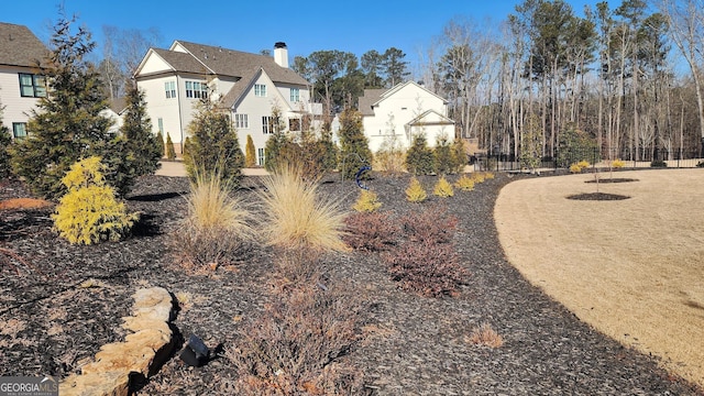 view of home's exterior featuring fence and a chimney