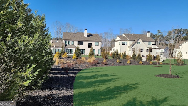view of property's community with a yard and a residential view