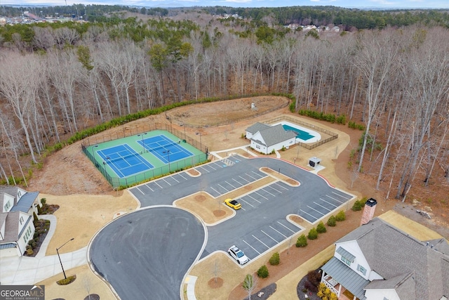 birds eye view of property with a view of trees