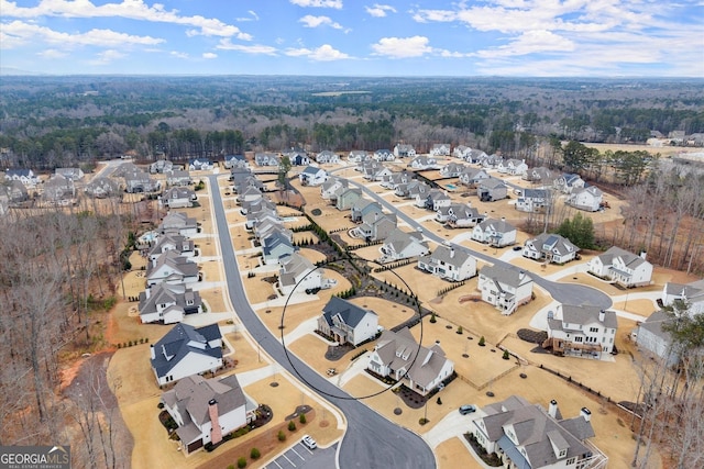 birds eye view of property with a wooded view and a residential view