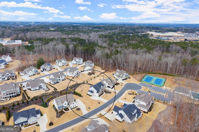 birds eye view of property with a residential view and a view of trees