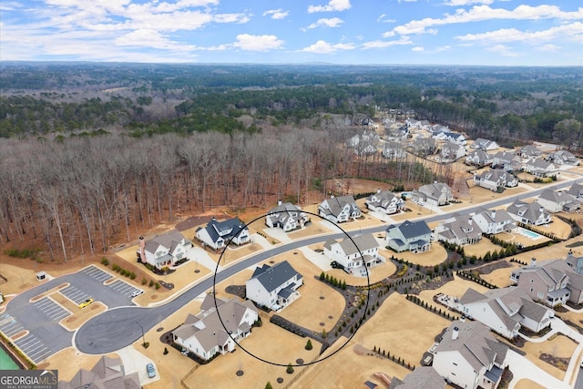 bird's eye view featuring a forest view and a residential view