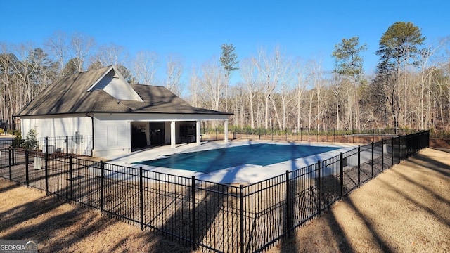 view of swimming pool featuring fence, a fenced in pool, and a patio