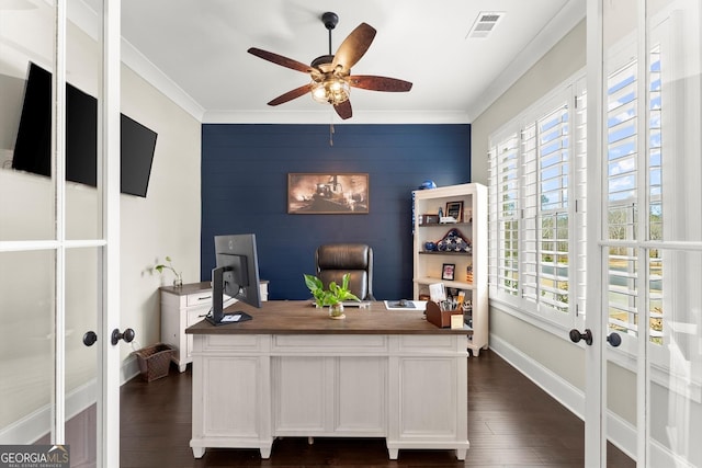 office featuring a wealth of natural light, an accent wall, visible vents, and ceiling fan