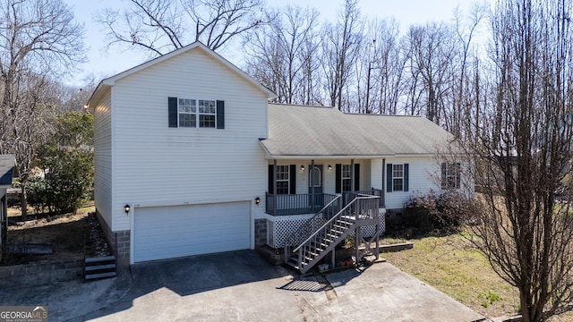 view of front of property featuring stairway, aphalt driveway, roof with shingles, an attached garage, and a porch