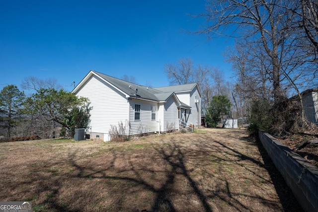 view of property exterior featuring cooling unit, crawl space, a lawn, and fence