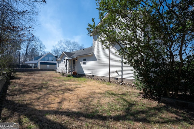 exterior space with crawl space and a yard