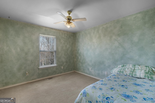 unfurnished bedroom featuring ceiling fan, carpet floors, visible vents, and baseboards