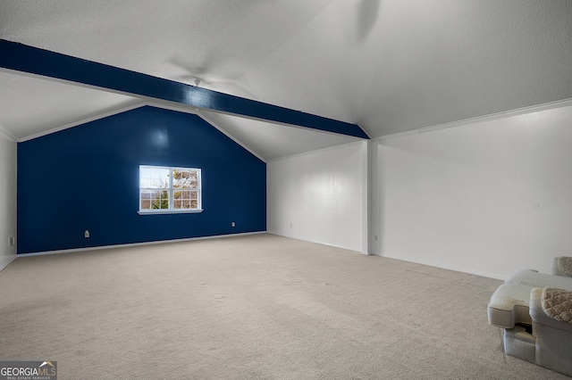 additional living space with carpet, lofted ceiling with beams, and a textured ceiling