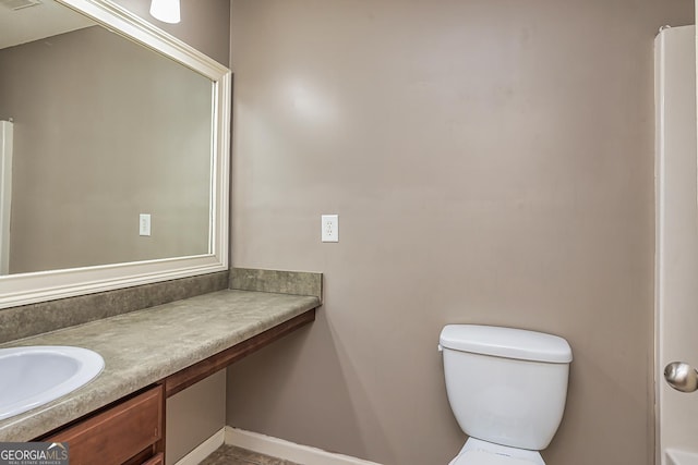 bathroom with toilet, visible vents, and vanity