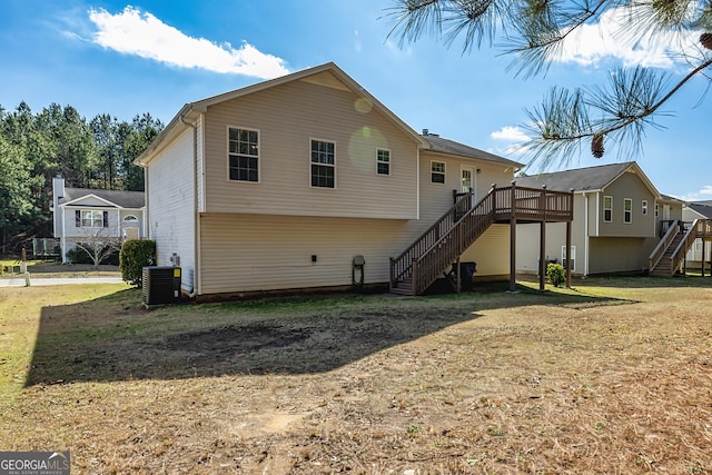 rear view of property featuring stairs, a lawn, cooling unit, and a wooden deck