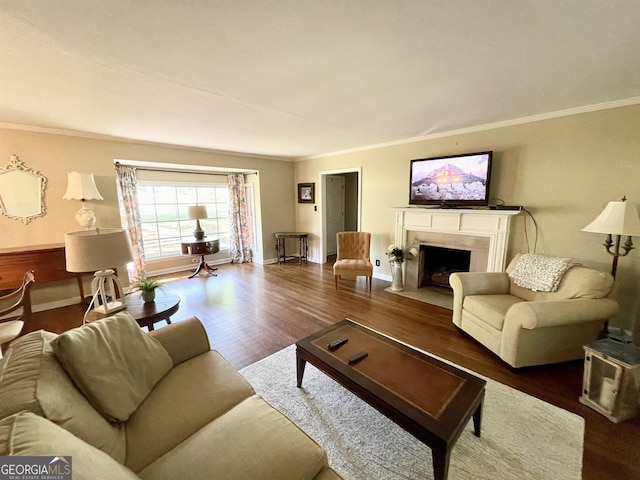 living room featuring ornamental molding, dark wood-style flooring, a high end fireplace, and baseboards