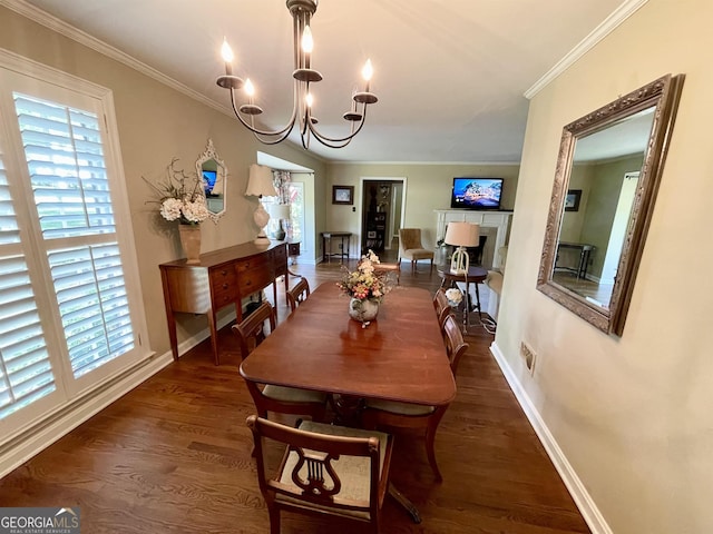 dining area featuring baseboards, dark wood-style floors, an inviting chandelier, crown molding, and a fireplace