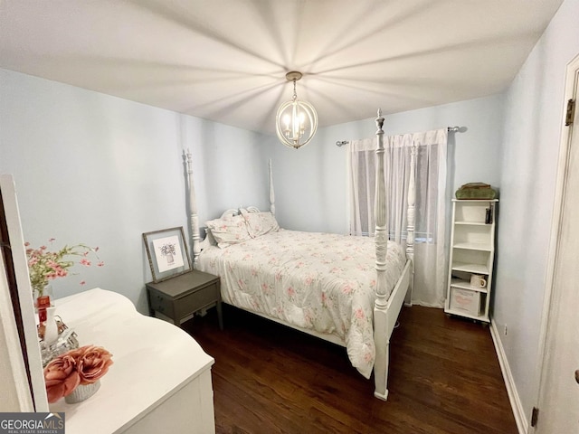 bedroom with dark wood-style floors and an inviting chandelier