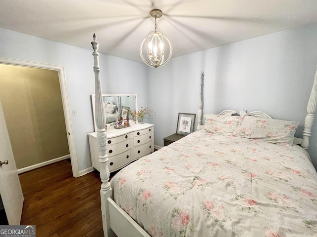 bedroom featuring baseboards, a chandelier, and dark wood-style flooring